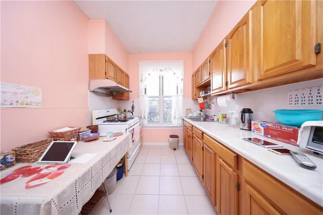 a kitchen with stainless steel appliances a sink stove and cabinets