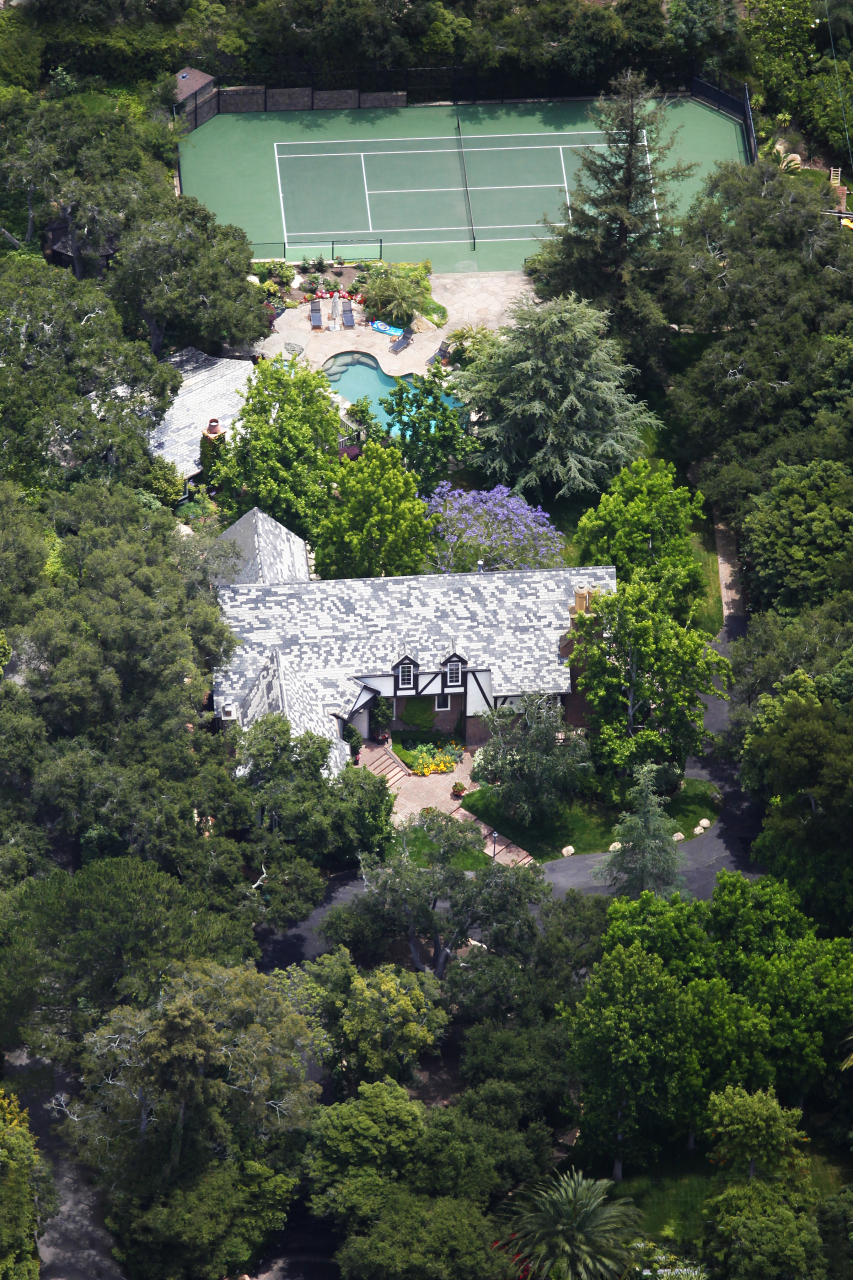 an aerial view of a house with a yard