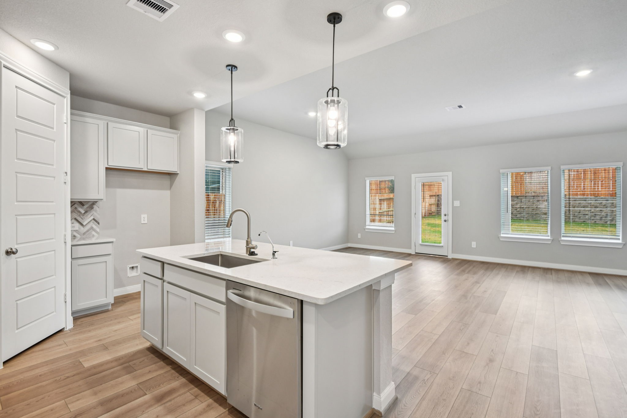 224 Raine Manor Montgomery, TX 77316 - Photo 11 of 50 a kitchen that has a sink a window and stainless steel appliances