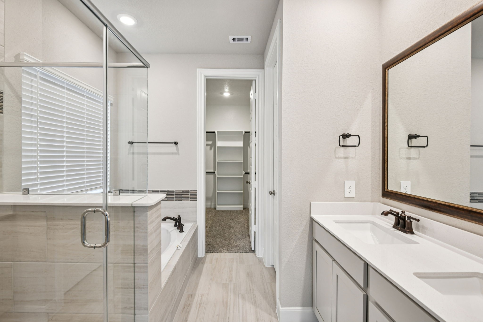 224 Raine Manor Montgomery, TX 77316 - Photo 27 of 50 a bathroom with a double vanity sink a mirror and shower