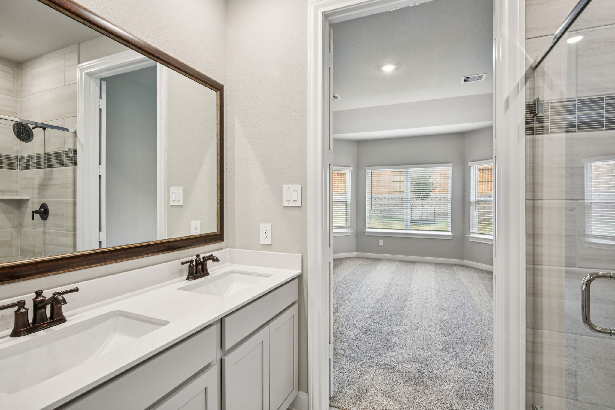 224 Raine Manor Montgomery, TX 77316 - Photo 28 of 50 a bathroom with a double vanity sink mirror and shower