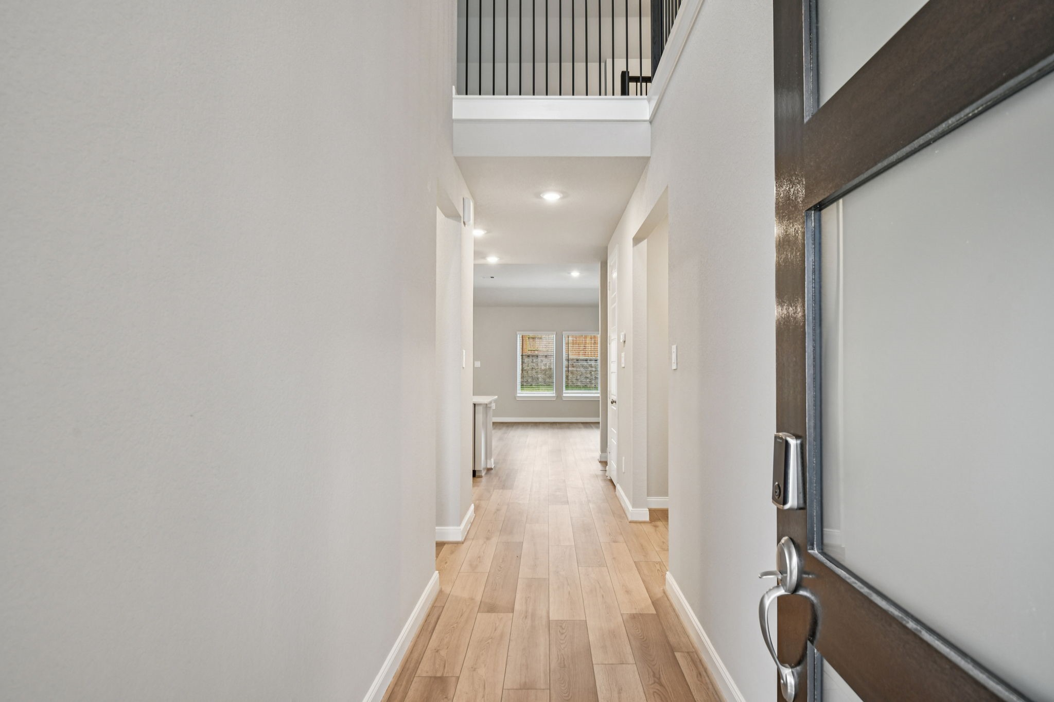 224 Raine Manor Montgomery, TX 77316 - Photo 4 of 50 a view of a hallway with wooden floor and staircase