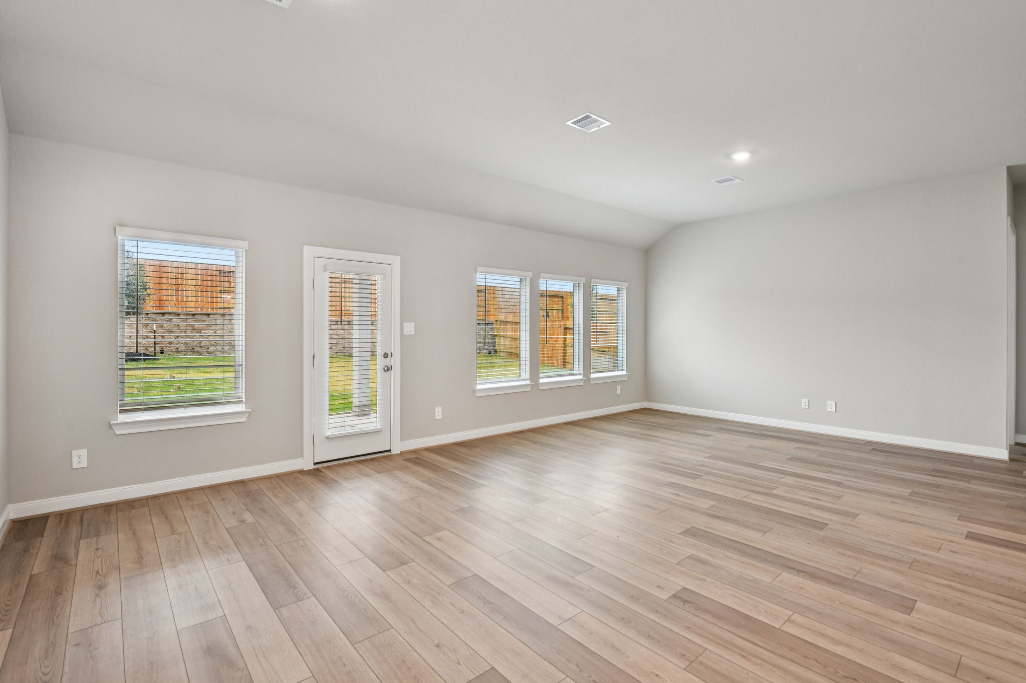 224 Raine Manor Montgomery, TX 77316 - Photo 5 of 50 an empty room with wooden floor and windows