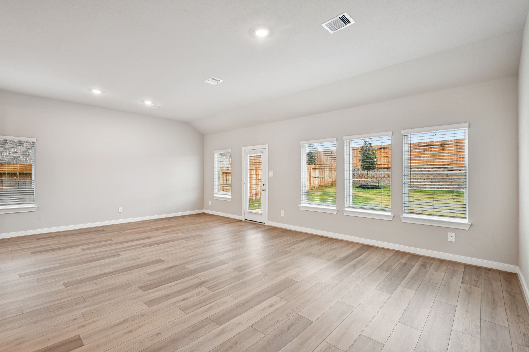 224 Raine Manor Montgomery, TX 77316 - Photo 7 of 50 an empty room with wooden floor and windows