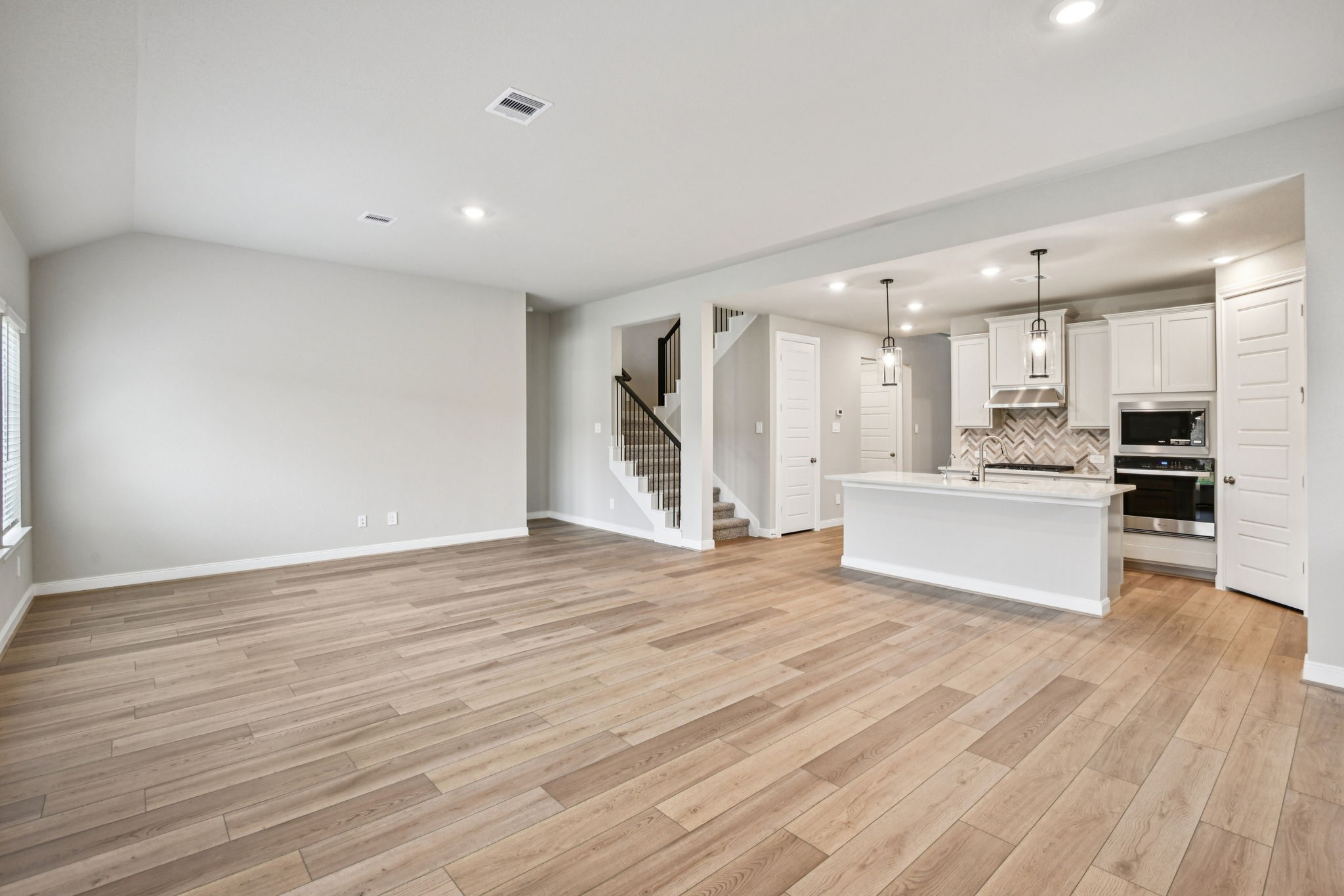 224 Raine Manor Montgomery, TX 77316 - Photo 8 of 50 a view of kitchen with kitchen island wooden floor center island and stainless steel appliances