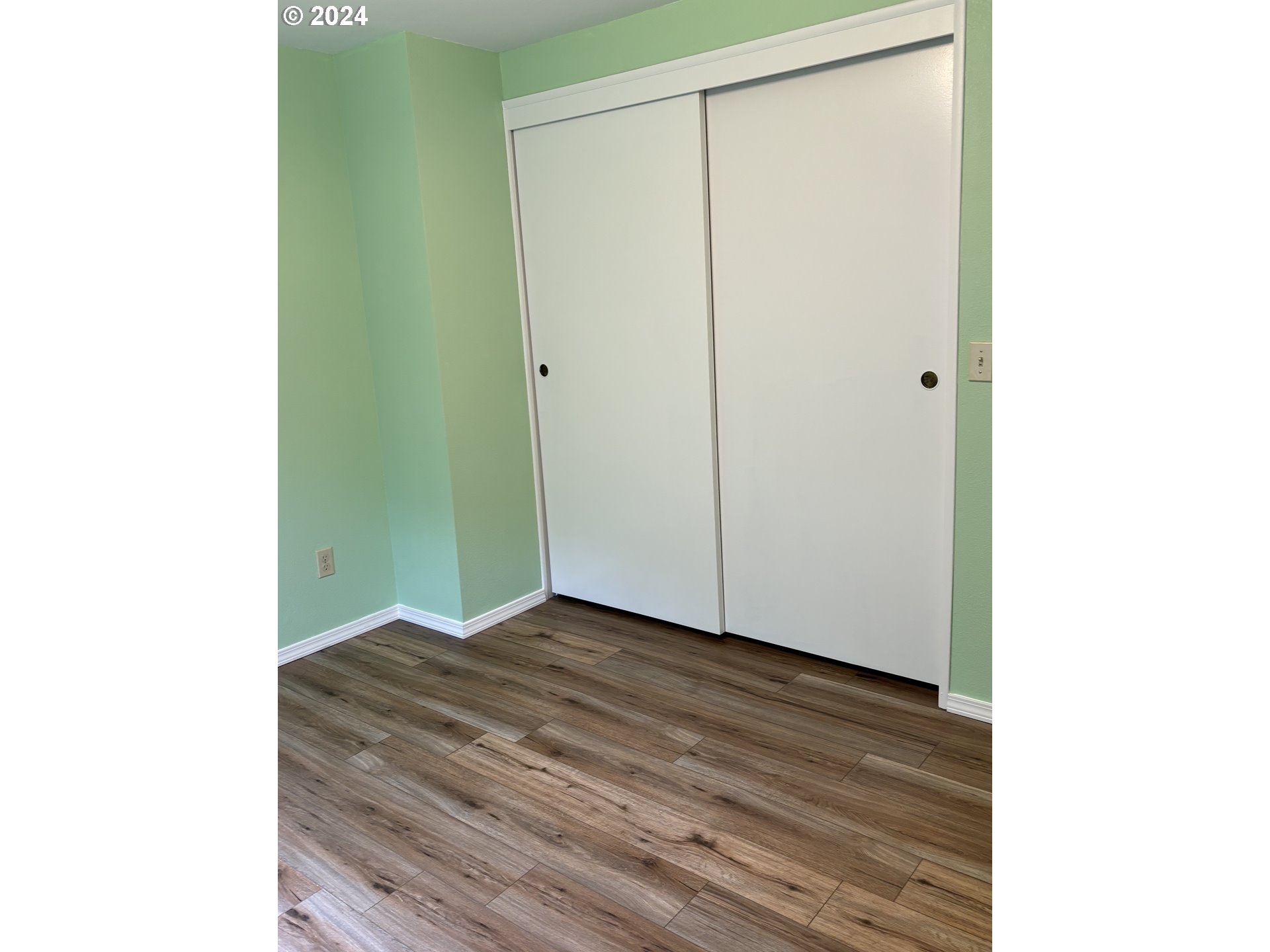629 Coal Creek Road Longview, WA 98632 - Photo 18 of 26 a view of an empty room with wooden floor