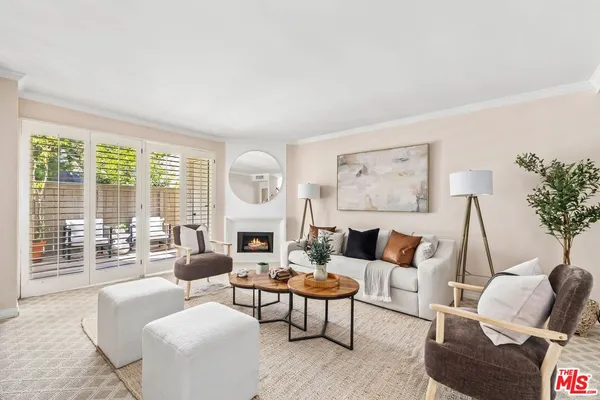a living room with furniture or couch and a large window