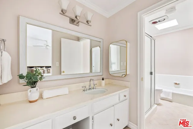 a bathroom with a sink double vanity granite tub and shower