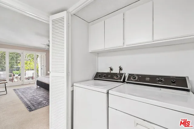a utility room with closet dryer and washer