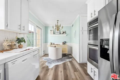 a kitchen with a refrigerator and a sink