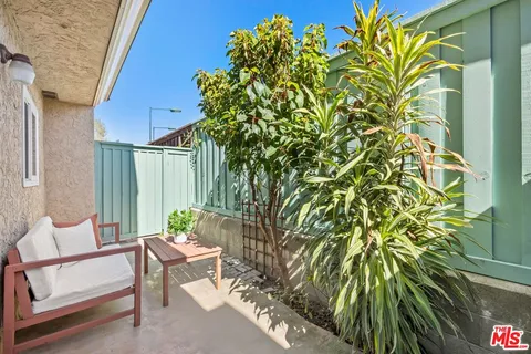 a view of a chairs and table in the patio