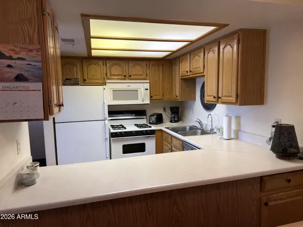 a kitchen with a sink a stove and a refrigerator