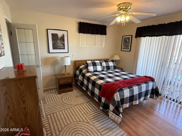 a bedroom with a bed lamps and a large mirror