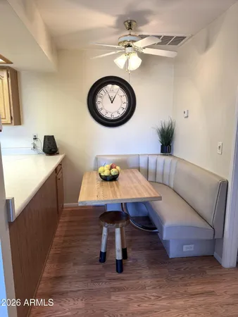 a living room with a couch and a clock on the wall