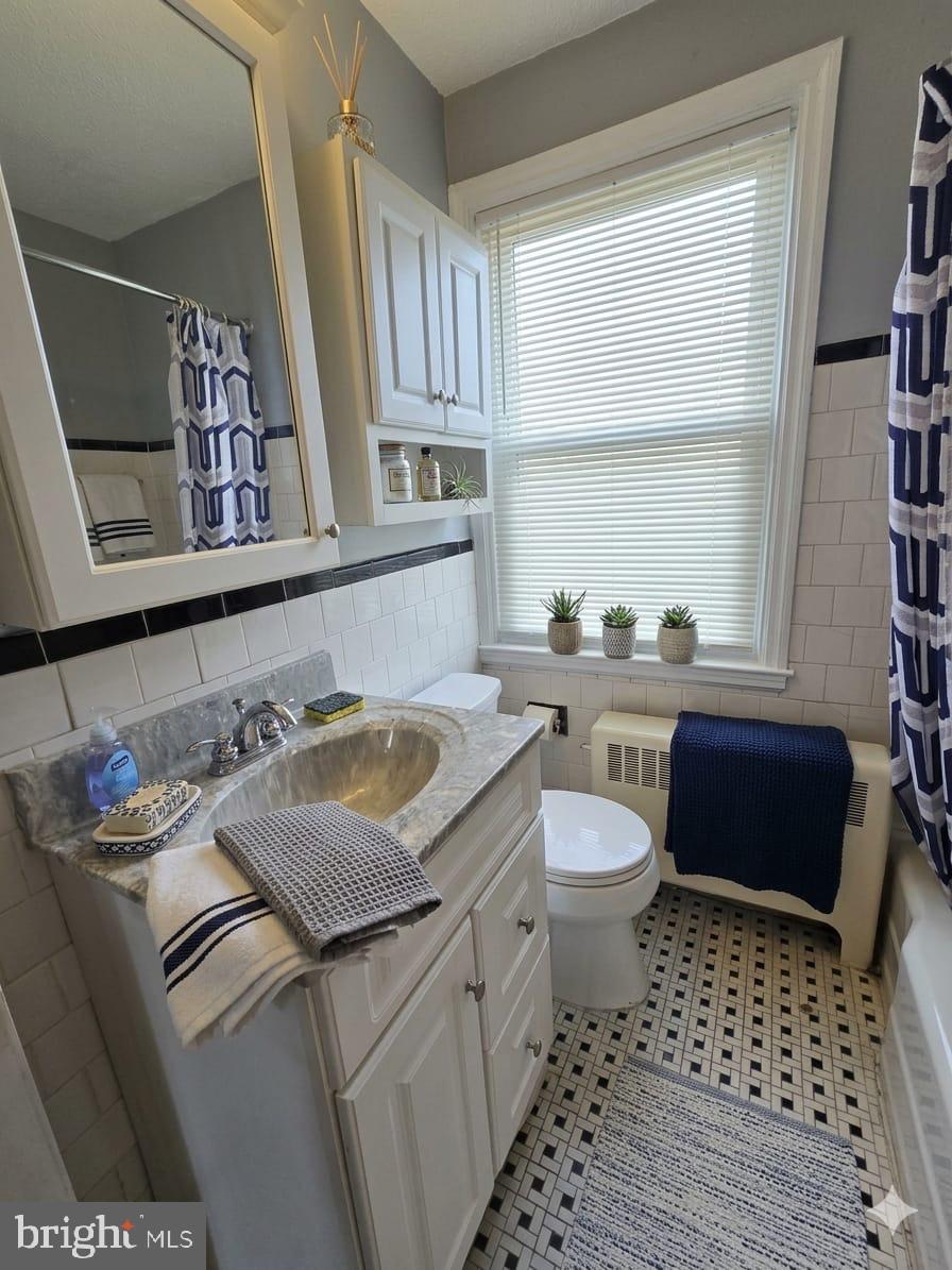 6105 Frederick Road Catonsville, MD 21228 - Photo 25 of 38 a bathroom with a sink toilet and window