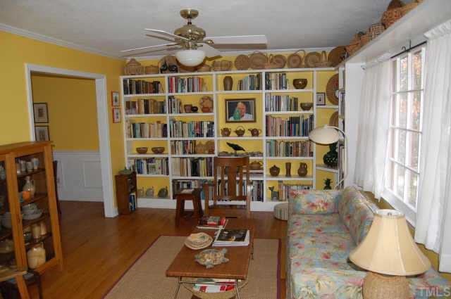 3704 Oak Park Road Raleigh, NC 27612 - Photo 3 of 12 a living room with couches and dining table with wooden floor