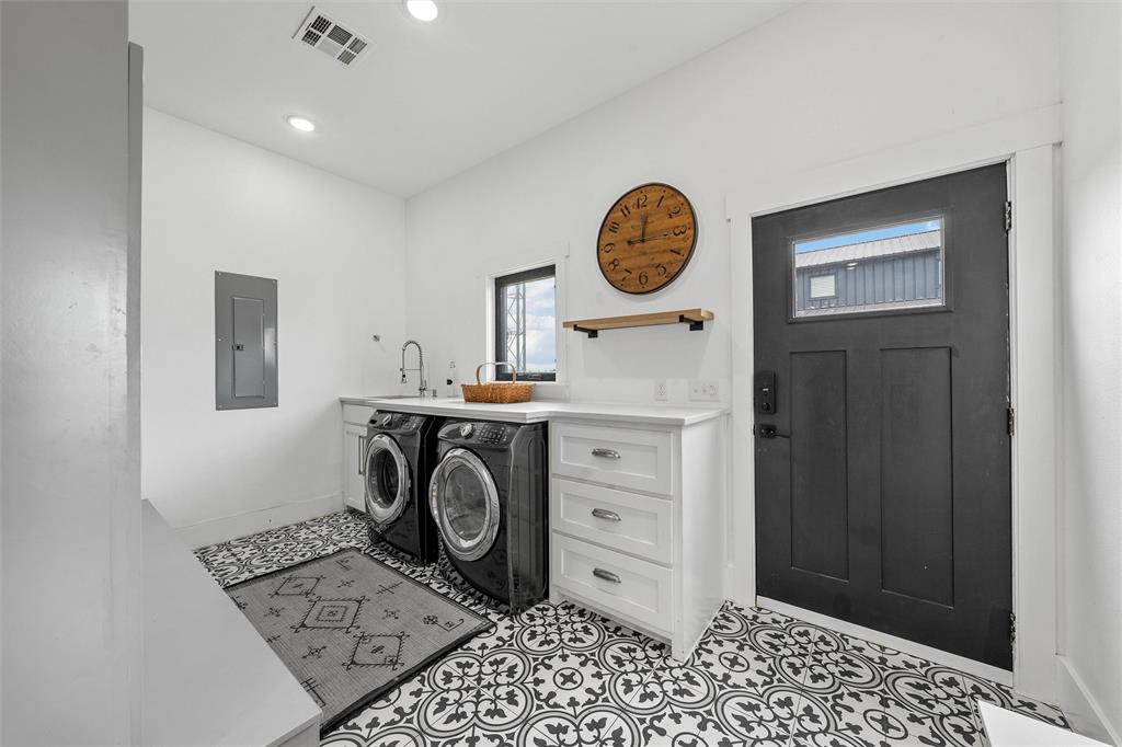 1197 Prairie Chapel Road Crawford, TX 76638 - Photo 19 of 40 Clothes washing area with electric panel, healthy amount of natural light, baseboards, washing machine and clothes dryer, and recessed lighting