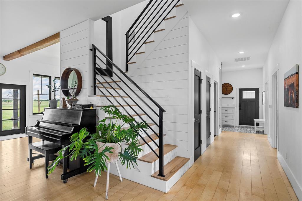 1197 Prairie Chapel Road Crawford, TX 76638 - Photo 20 of 40 Hallway with stairway, plenty of natural light, recessed lighting, and beam ceiling