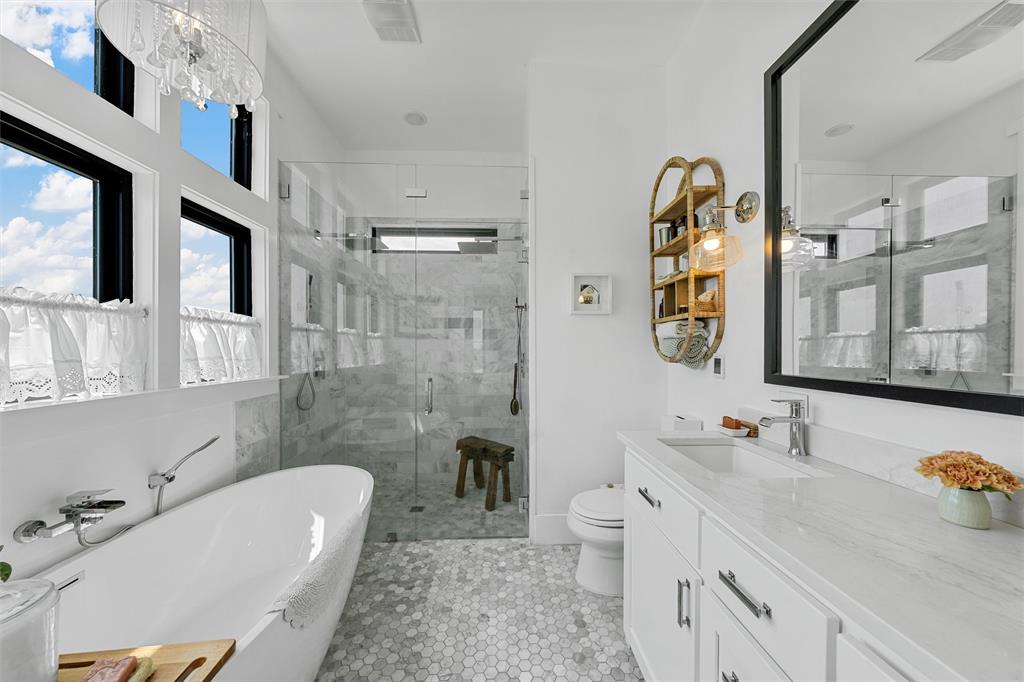1197 Prairie Chapel Road Crawford, TX 76638 - Photo 23 of 40 Bathroom featuring toilet, a shower stall, vanity, a freestanding tub, and tile patterned floors