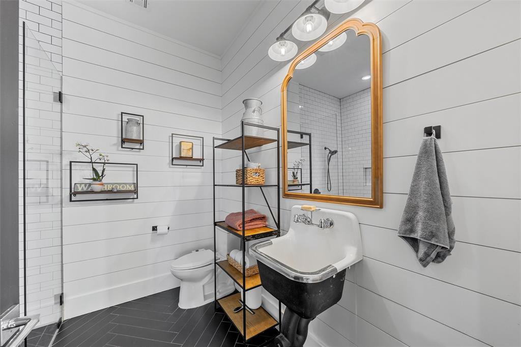 1197 Prairie Chapel Road Crawford, TX 76638 - Photo 26 of 40 Full bathroom featuring toilet, tile patterned flooring, a shower, and wooden walls
