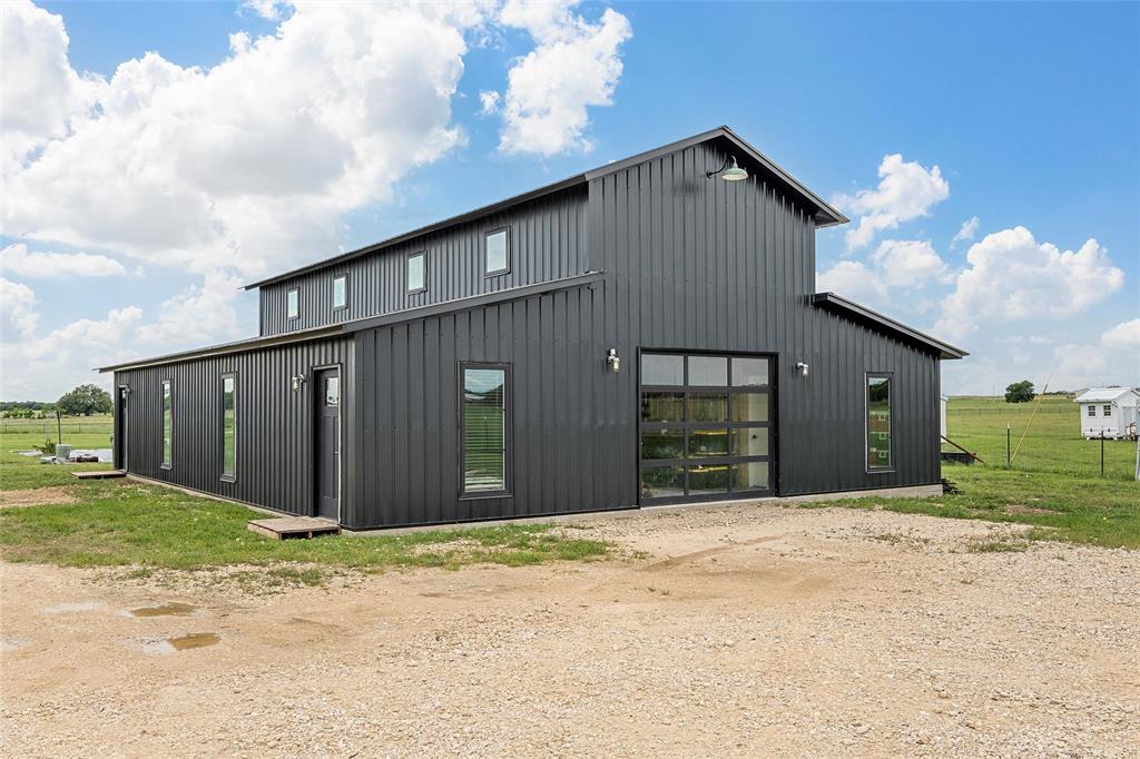1197 Prairie Chapel Road Crawford, TX 76638 - Photo 34 of 40 View of outdoor structure with dirt driveway and an outbuilding