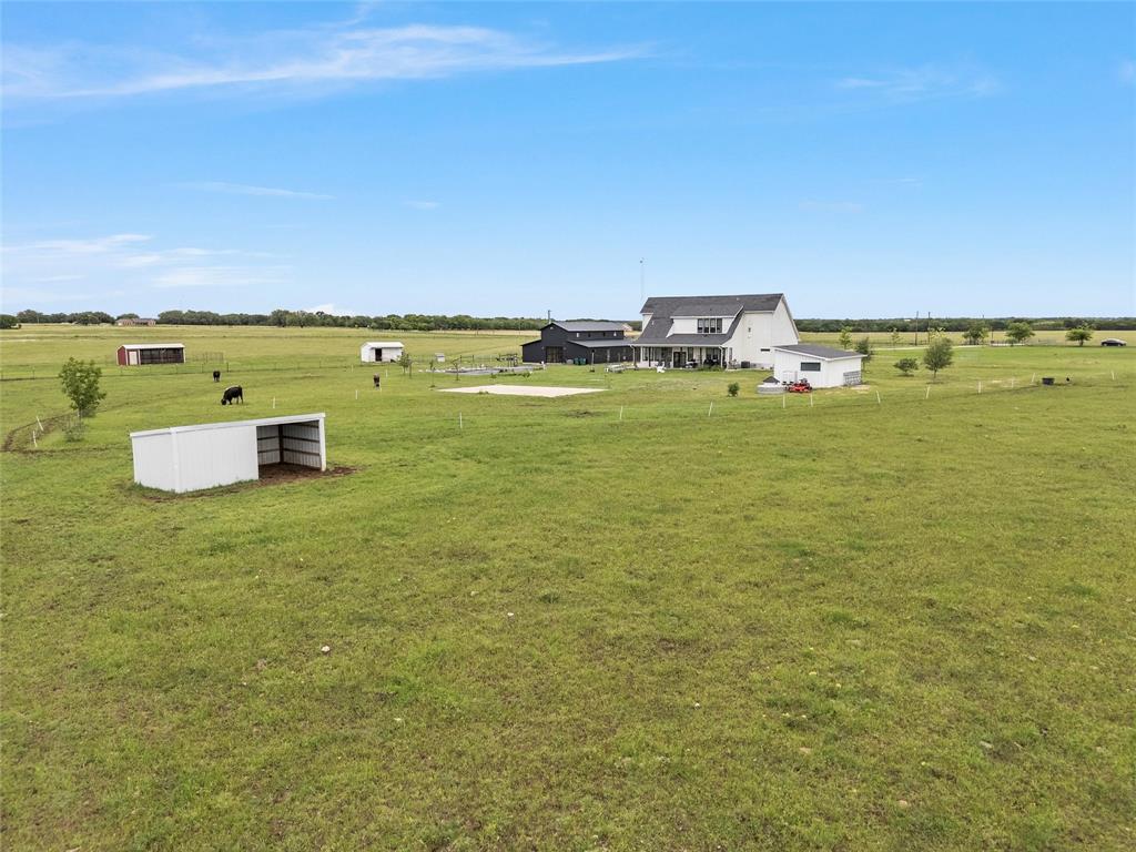 1197 Prairie Chapel Road Crawford, TX 76638 - Photo 40 of 40 View of green lawn featuring an outbuilding, a view of rural / pastoral area, and an outdoor structure