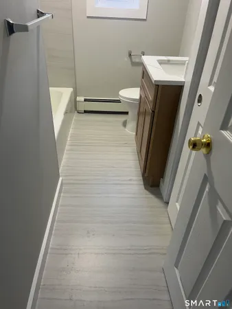 a bathroom with a sink a toilet and a shower