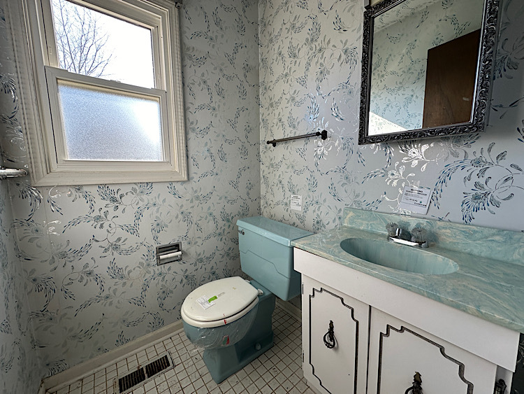 713 Old Post Road Buffalo Grove, IL 60089 - Photo 2 of 2 a bathroom with a granite countertop toilet sink and mirror