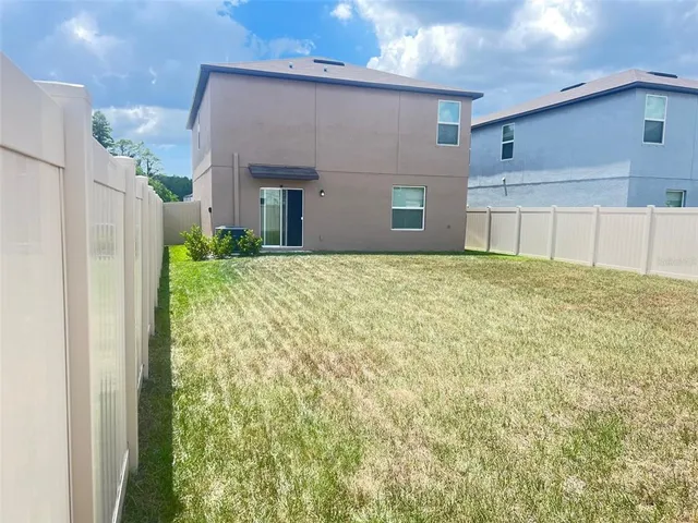 a view of a backyard of the house