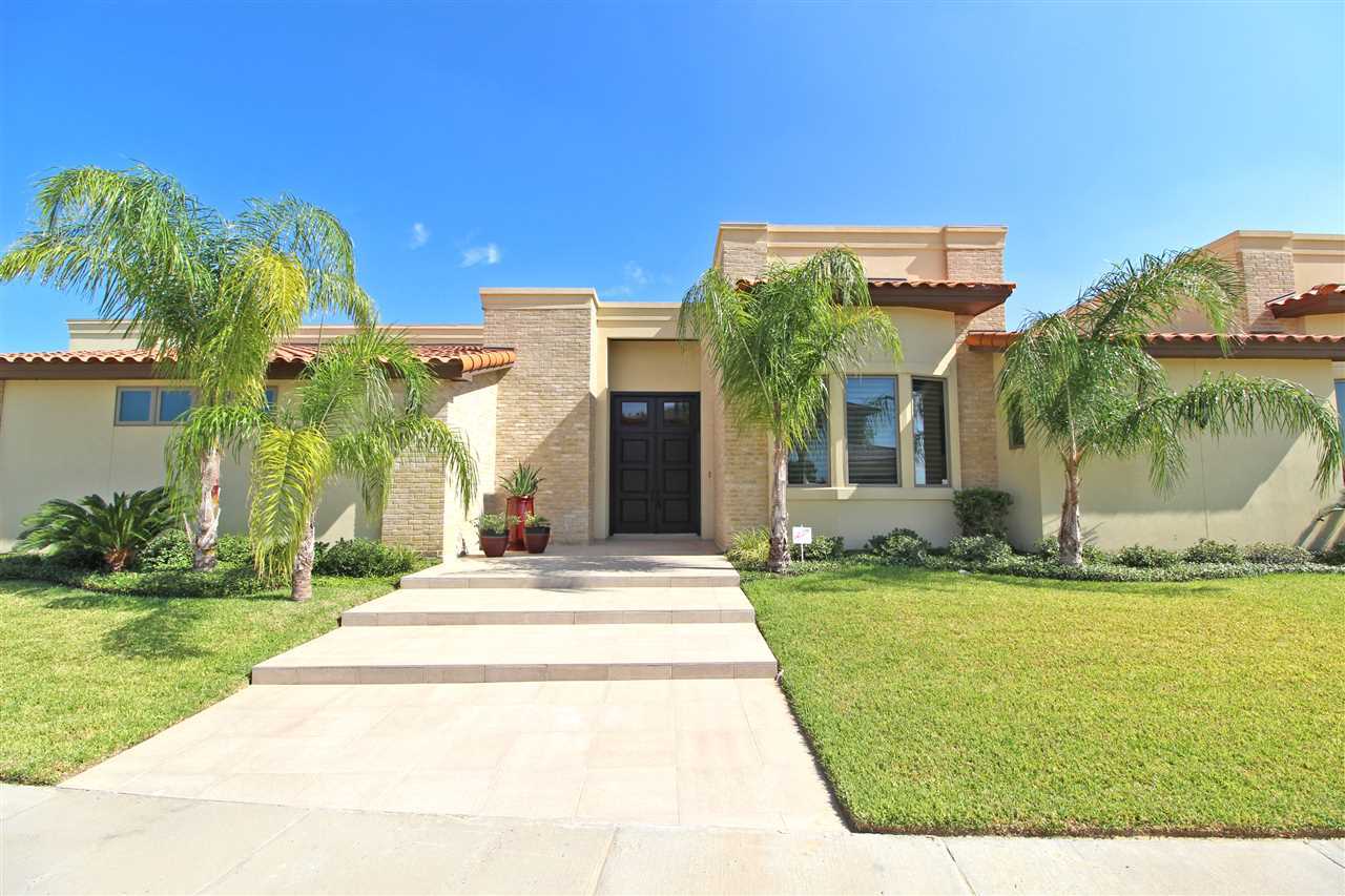 a view of a house with fountain in front of main door