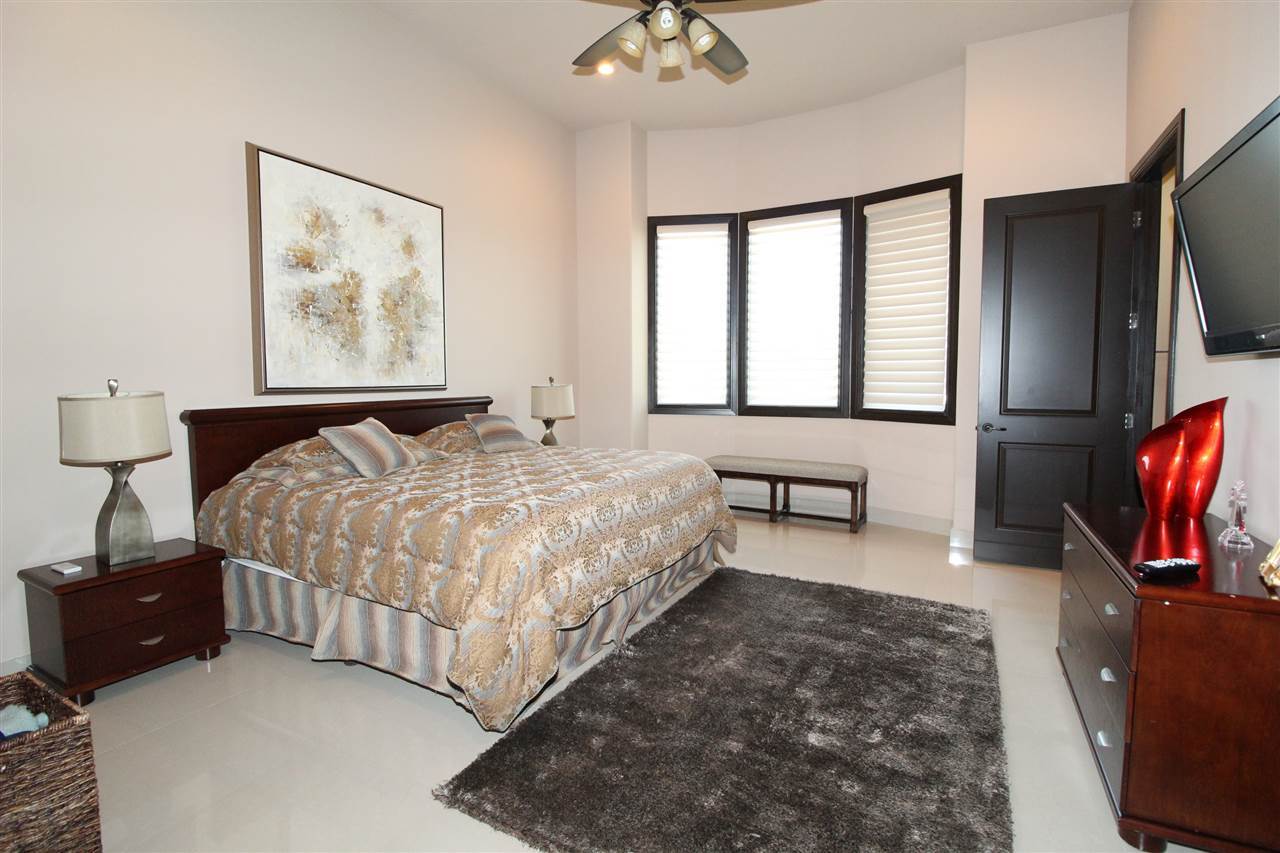 8314 Deer Ridge Boulevard Laredo, TX 78045 - Photo 14 of 20 a bedroom with a bed and a flat screen television