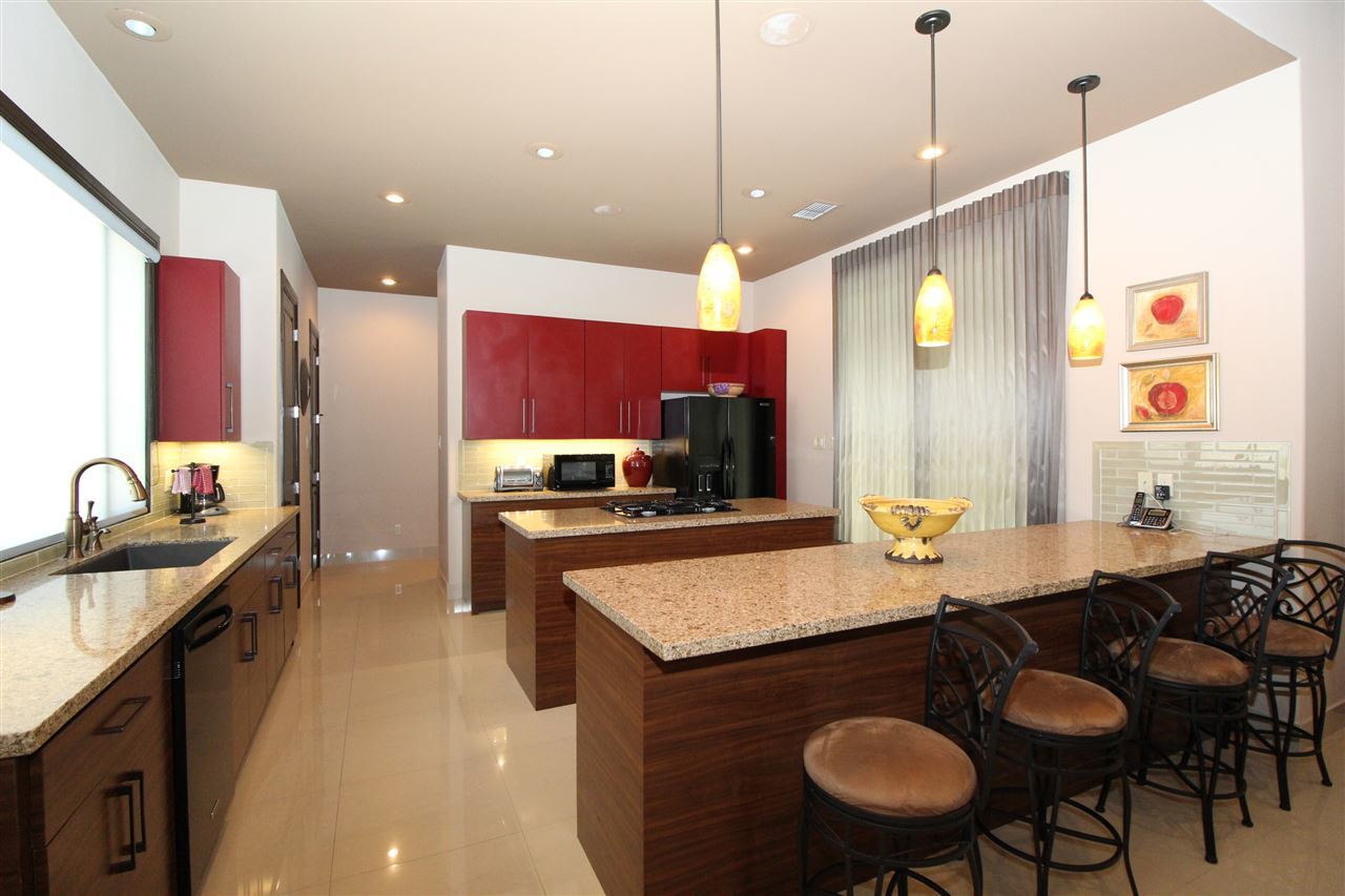 8314 Deer Ridge Boulevard Laredo, TX 78045 - Photo 6 of 20 a kitchen with a stove a sink and a refrigerator