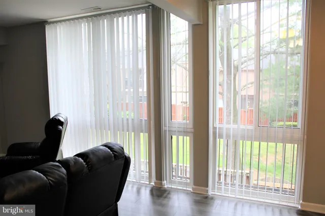 a living room with furniture and a floor to ceiling window