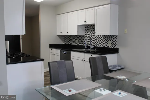 a kitchen with stainless steel appliances a refrigerator and a stove top oven