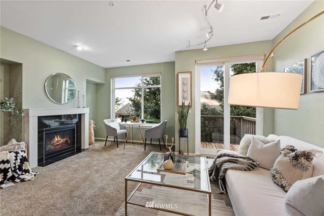 84 Sky Ridge Road Northwest, Unit 803 Issaquah, WA 98027 - Photo 4 of 31 a living room with furniture and a fireplace
