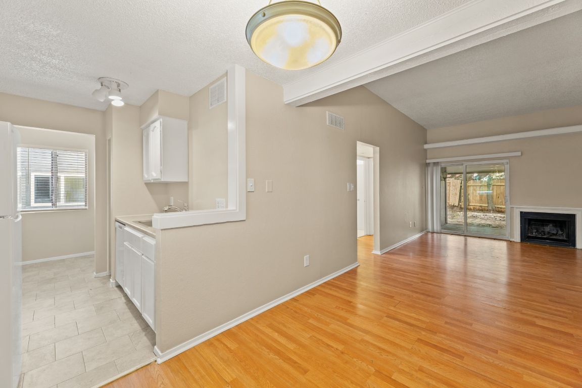 6901 Woodhue Drive, Unit A Austin, TX 78745 - Photo 14 of 34 a view of an empty room with window and wooden floor