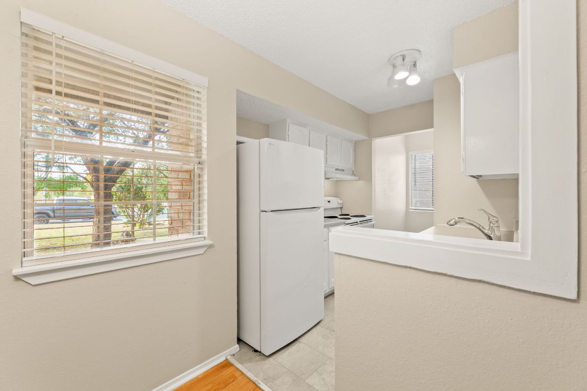 6901 Woodhue Drive, Unit A Austin, TX 78745 - Photo 15 of 34 a white refrigerator freezer and a window