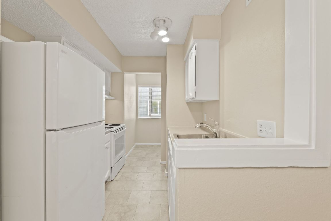 6901 Woodhue Drive, Unit A Austin, TX 78745 - Photo 16 of 34 a bathroom with a sink and a mirror