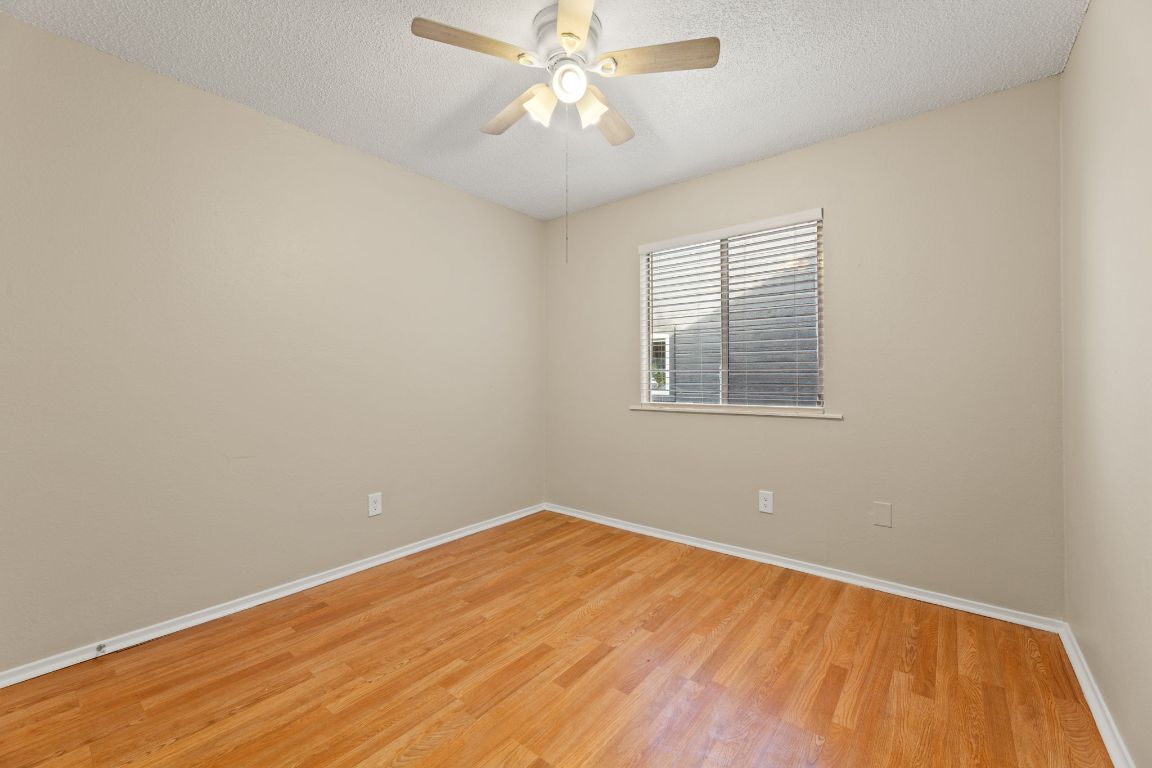 6901 Woodhue Drive, Unit A Austin, TX 78745 - Photo 23 of 34 an empty room with a window and ceiling fan