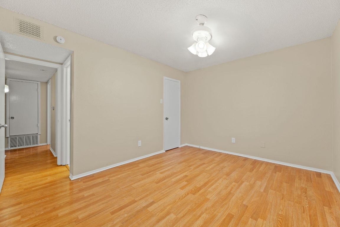 6901 Woodhue Drive, Unit A Austin, TX 78745 - Photo 26 of 34 a view of empty room with wooden floor and fan