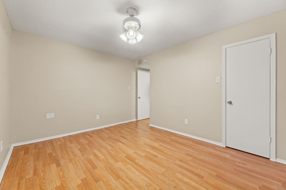 6901 Woodhue Drive, Unit A Austin, TX 78745 - Photo 27 of 34 a view of an empty room with wooden floor
