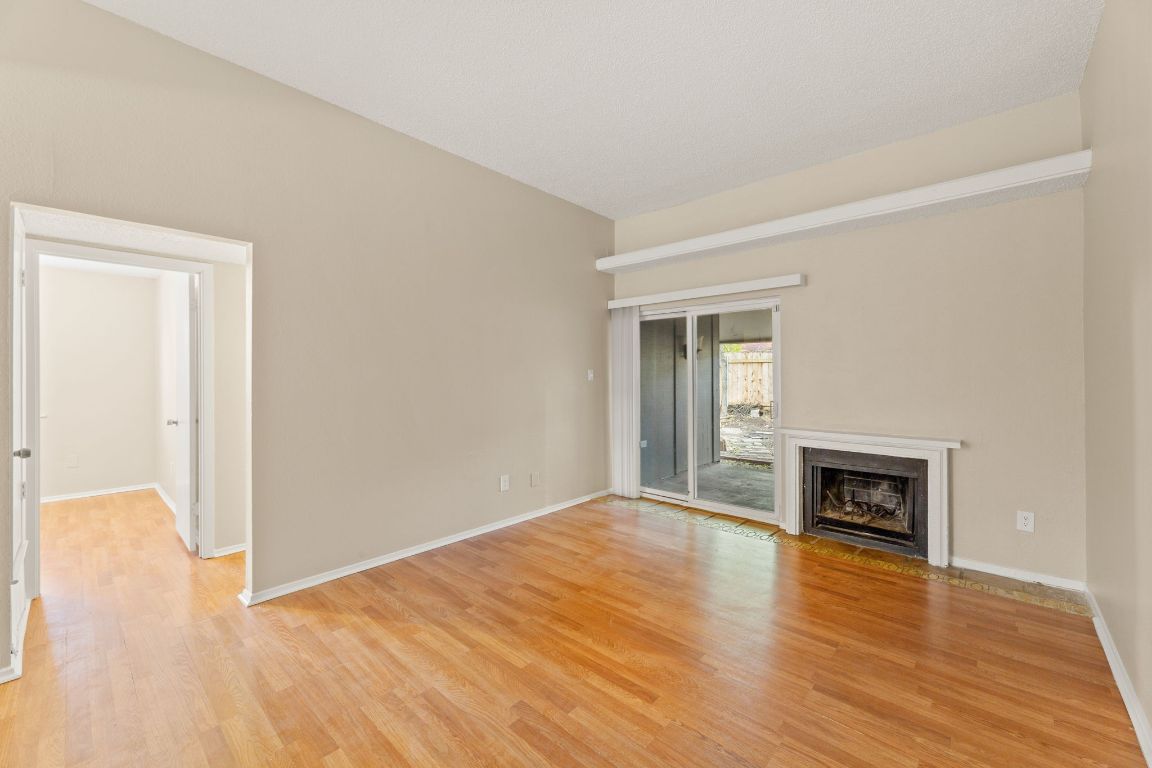 6901 Woodhue Drive, Unit A Austin, TX 78745 - Photo 7 of 34 a view of an empty room with wooden floor and a window