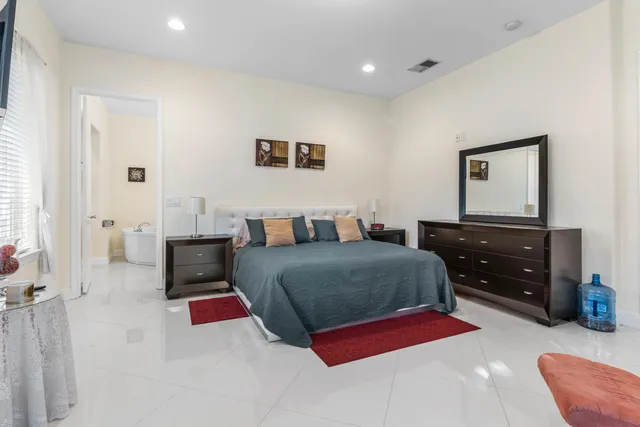 a bedroom with a bed and a couch