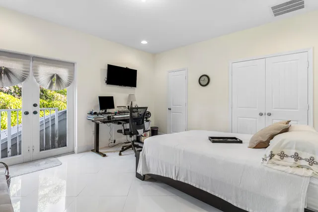 a bedroom with a bed and a flat screen tv