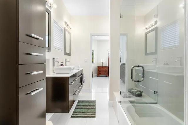 a bathroom with a tub sink and mirror