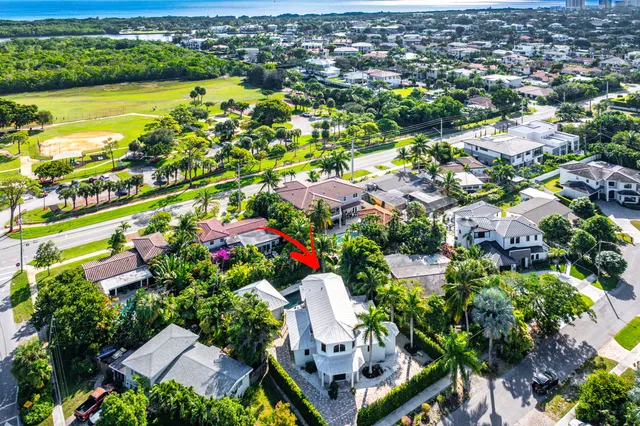 an aerial view of residential houses with outdoor space and lake view