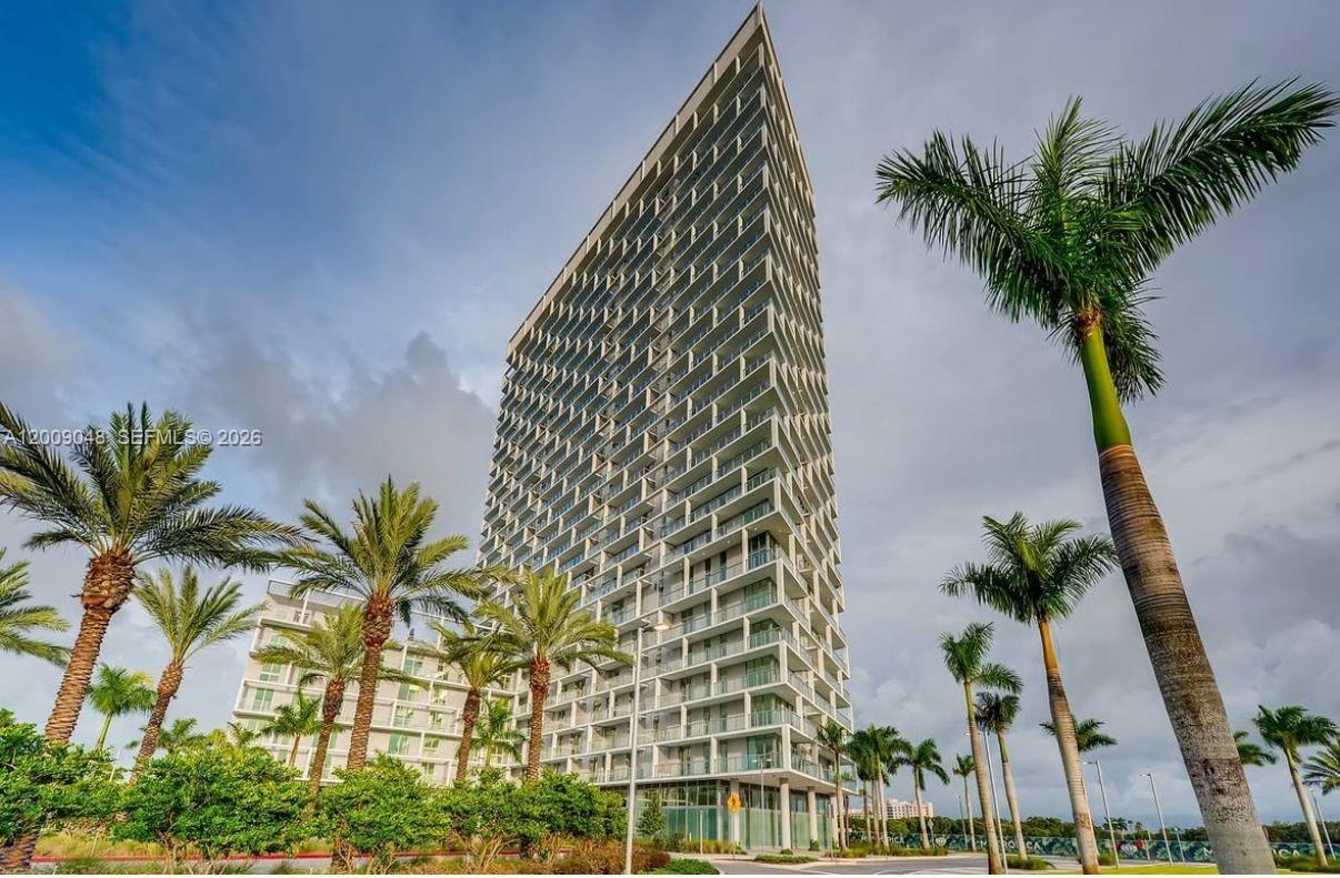2000 Metropica Way, Unit 901 Sunrise, FL 33323 - Photo 22 of 25 a view of a palm plant that is in front of a building
