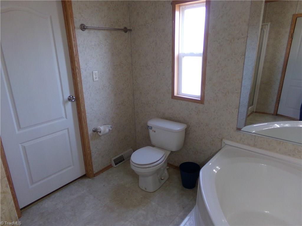 602 Booker T Womble Road Randleman, NC 27317 - Photo 11 of 26 Door to walk in closet in master bath.