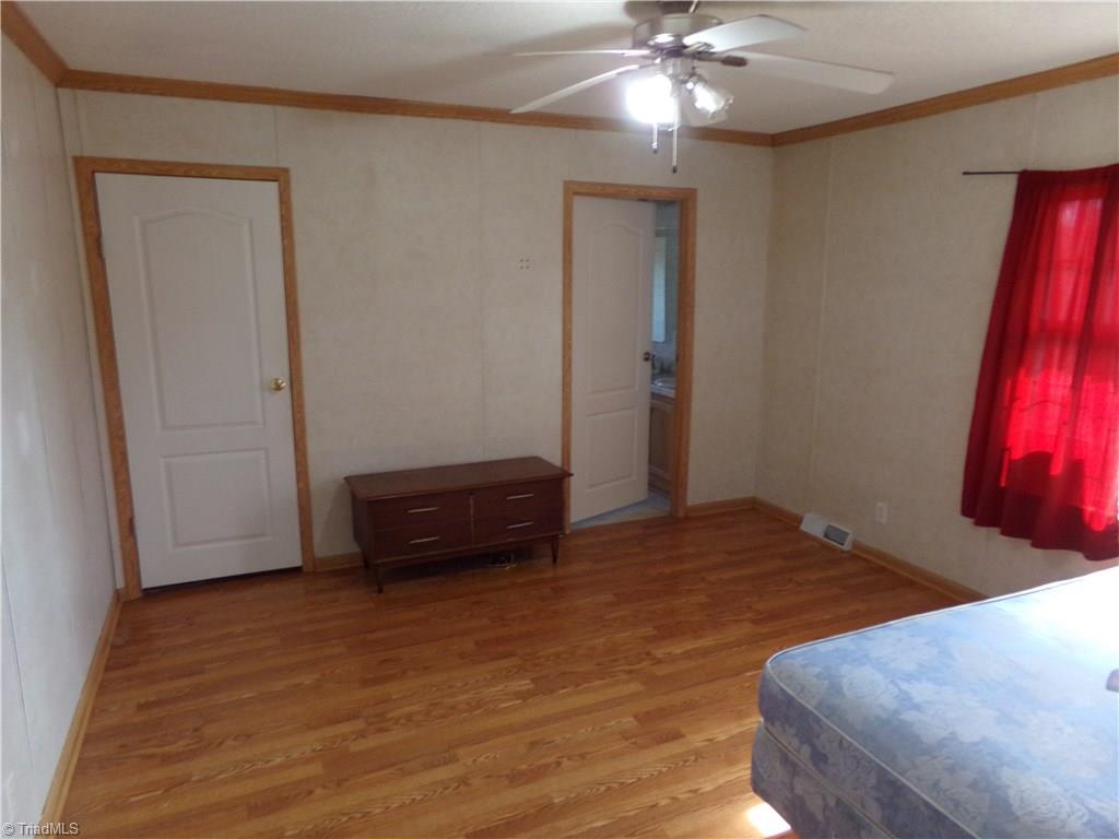 602 Booker T Womble Road Randleman, NC 27317 - Photo 14 of 26 Large Master bedroom. Left door goes to walk in closet. Right door goes to bath