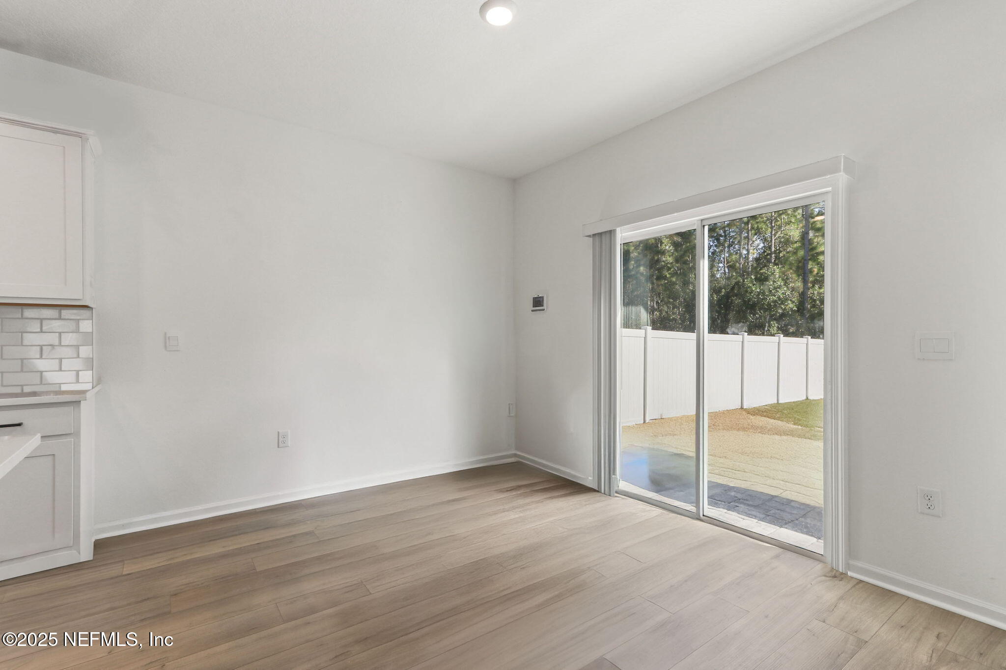 2267 Shady Breeze Ln Green Cove Springs Green Cove Springs, FL 32043 - Photo 11 of 17 an empty room with wooden floor and windows